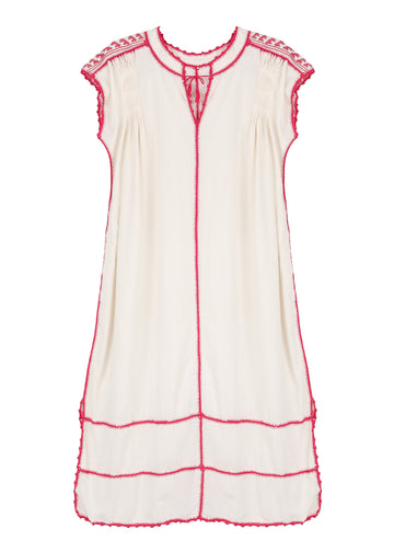 A short-sleeved white and pink dress with hand-crocheted details and a pleated design, featuring Mayan and Mixtec influences.
