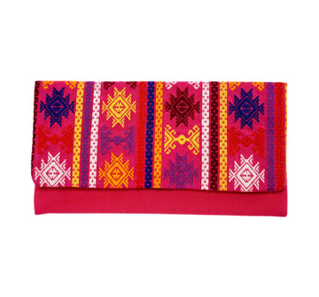 Vibrant pink and multi-colored hand-embroidered clutch from Guatemala. Made by women-weavers. Fully lined, with an interior zippered pocket. 